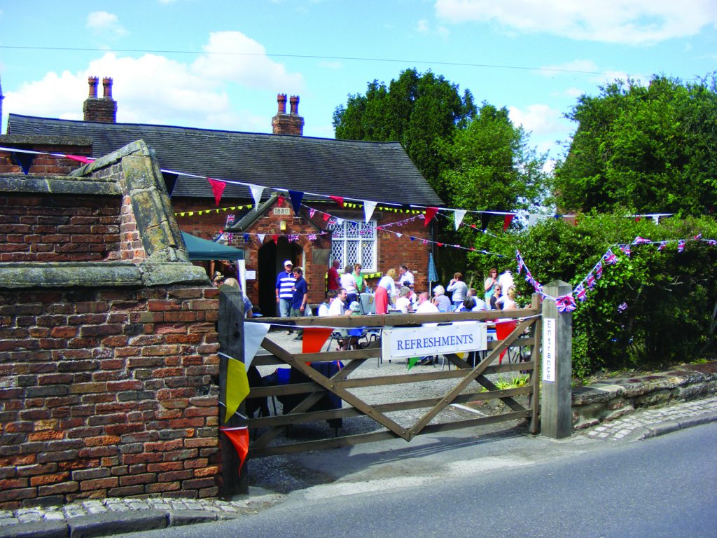 Photo of exterior of the Old School Room building, Cossall, during an event